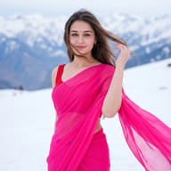 Serene Snowy Saree Portrait AI Photo Editing Prompt. AI generated photorealistic portrait of a joyful woman in a vibrant pink saree, standing gracefully against a breathtaking winter mountain backdrop.