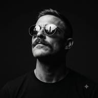 Gemini AI Generated Minimalist black and white fashion portrait of a man with a mustache gazing upward confidently against a dark background.