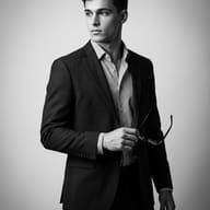 AI-generated old money aesthetic style black and white studio portrait of a young man in a dark suit and striped shirt looking away.