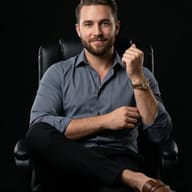 Man in Office Chair Portrait AI Photo Editing Prompt. AI generated studio portrait of a bearded man in a grey shirt and black pants sitting cross-legged in a black leather office chair.