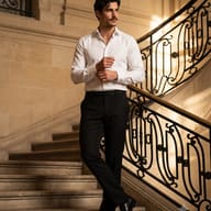 Stylish Man on Ornate Staircase Fashion Portrait AI Photo Editing Prompt. AI generated portrait of a stylish man with a mustache in a white shirt and black trousers adjusting his cuffs on a grand stone staircase with ornate railings.