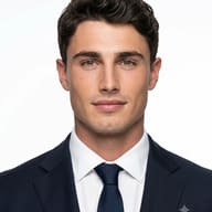 AI Image Prompt: Premium LinkedIn profile picture of a handsome man in a navy suit, white shirt, and navy tie with a silver clip against a clean white backdrop.