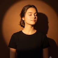 Spotlight Portrait Photography AI Photo Editing Prompt. AI generated studio portrait of a young woman with eyes closed and hair in a bun under a warm spotlight.
