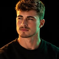 Cinematic Dual-Tone Portrait AI Photo Editing Prompt. AI generated studio portrait of a young man in a black sweater, lit with warm orange and cool teal split lighting against a black background.