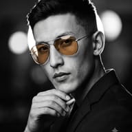 Gemini AI Generated Monochrome photo of a confident man with color-pop amber glasses resting his hand on his chin.