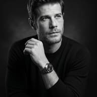 AI Prompt: Fine-art black-and-white portrait of a contemplative man in a dark crew-neck sweater.