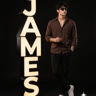 Man Leaning on Illuminated Name Sign Fashion Portrait AI Prompt. AI generated studio portrait of a man in a brown shirt and black pants holding sunglasses next to stacked, glowing letters spelling 'James'.