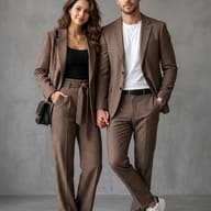 Couple in Matching Plaid Suits AI Photo Editing Prompt. AI generated studio portrait of a stylish couple holding hands while wearing coordinated brown plaid suits in a modern studio setting.