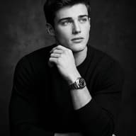 AI Image Prompt: Monochrome low-key portrait of a young man in a black sweater looking upward.