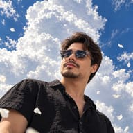AI Generated Dramatic wide-angle photography of a confident man in a black button-up shirt, posing against a deep blue sky, giant cloud formations, and floating petals.
