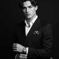 AI generated Black and White studio portrait of a handsome man in a dark double-breasted suit with a pocket square adjusting his silver chronograph watch.