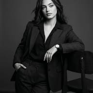 Woman Professional Portrait Prompt. AI-generated monochrome studio portrait of an elegant professional woman in a dark pinstripe suit leaning on a wooden chair.