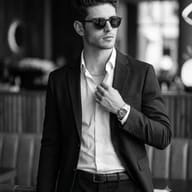 Cinematic B&W Male Photo AI Prompt. AI generated realistic portrait of a stylish man wearing sunglasses and a luxury watch, adjusting his open shirt collar.