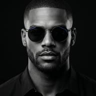 Cinematic Monochrome Man Portrait AI Photo Editing Prompt. AI generated studio portrait of a sharply groomed man in round sunglasses under dramatic dark lighting.