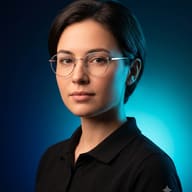 Studio Portrait Woman with Glasses AI Photo Editing Prompt. AI generated studio portrait of a woman with short dark hair, wearing round glasses and a black polo shirt, with blue and cyan split lighting.