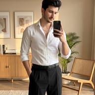 Indian Man in White Shirt Mirror Selfie Portrait AI Photo Editing Prompt. AI generated fashion portrait of a stylish man taking a sunlit mirror selfie in a modern, minimalist living room.