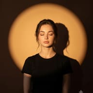 Dramatic Spotlight Portrait AI Prompt. AI generated dramatic portrait of a serene young woman with eyes closed, in a black t-shirt, centered within a precise circular spotlight casting a shadow.