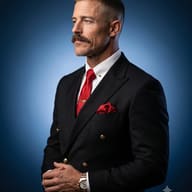 AI Image Prompt: Corporate side profile photo of a mature man with a mustache in a tailored black suit and red silk tie on a blue gradient background.