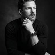 AI Generated High-contrast monochrome editorial portrait of a man with wavy hair and luxury watch.