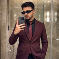 Stylish mature Man in Burgundy Blazer Mirror Selfie AI Photo Editing Prompt. AI generated realistic portrait of a young man with sunglasses taking a mirror selfie in a luxury marble bathroom wearing a burgundy textured blazer and black shirt.
