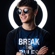 Man in Sunglasses Studio Portrait AI Photo Editing Prompt. AI generated studio portrait of a smiling young man in round sunglasses and a "Break the Rules" sweatshirt, arms crossed against a glowing neon ring light backdrop.