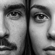 Close Up B&W Couple Portrait AI Photo Editing Prompt. AI generated macro portrait of a man and a woman showing highly detailed half faces side by side in monochrome.