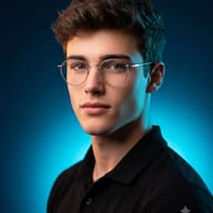Cinematic Studio Photography AI Prompt. AI generated portrait of a young man with round silver-framed glasses and brown wavy hair, wearing a black polo shirt against a vibrant blue background.