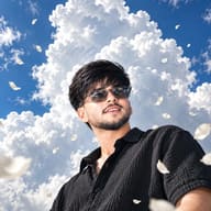 AI photo prompt: Photorealistic low-angle image of a stylish man wearing translucent sunglasses, standing under a dramatic blue summer sky with drifting flower petals.