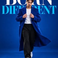 AI Photo Prompt: Modern menswear studio portrait showing a confident man walking in a double-breasted blue overcoat and black trousers with dramatic background text.