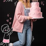 Creative Doodle Birthday Portrait AI Photo Editing Prompt. AI generated studio portrait of a cheerful blonde woman in denim overalls holding a lit pink cake against a dark background with cute hand-drawn doodles.