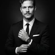 Classic Black and White Suit Portrait AI Photo Editing Prompt. AI generated studio portrait of a man in a sharp suit adjusting his cuff, prominently displaying a wristwatch against a dark background.