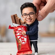 AI generated surreal photo manipulation of a smiling miniature man with an oversized head holding a large, partially eaten KitKat bar and being pinched by a giant human hand.