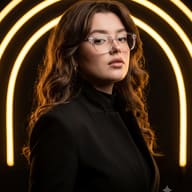 Prompt: Premium portrait of a young woman with long wavy hair, wearing clear glasses and a black blazer, illuminated by a smooth glowing golden neon arc.