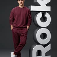 Custom 3D Name Text AI Photo Editing Prompt. AI generated studio portrait of a confident man in a relaxed maroon tracksuit leaning against sleek, giant silver 3D 'ROCK' customizable name typography on a moody dark background.