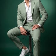 Gemini AI Generated Stylish man in a monochromatic green suit photoshoot leaning on a chrome stool.
