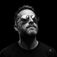 Gemini AI Generated Dramatic B&W medium close-up of a man with a short beard looking up into a dark void, with a tall city skyline reflected in his glasses.