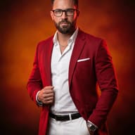 Man in Red Blazer AI Photo Editing Prompt. AI generated studio portrait of a bearded man wearing glasses and a red blazer over a white shirt and trousers against a warm textured background.